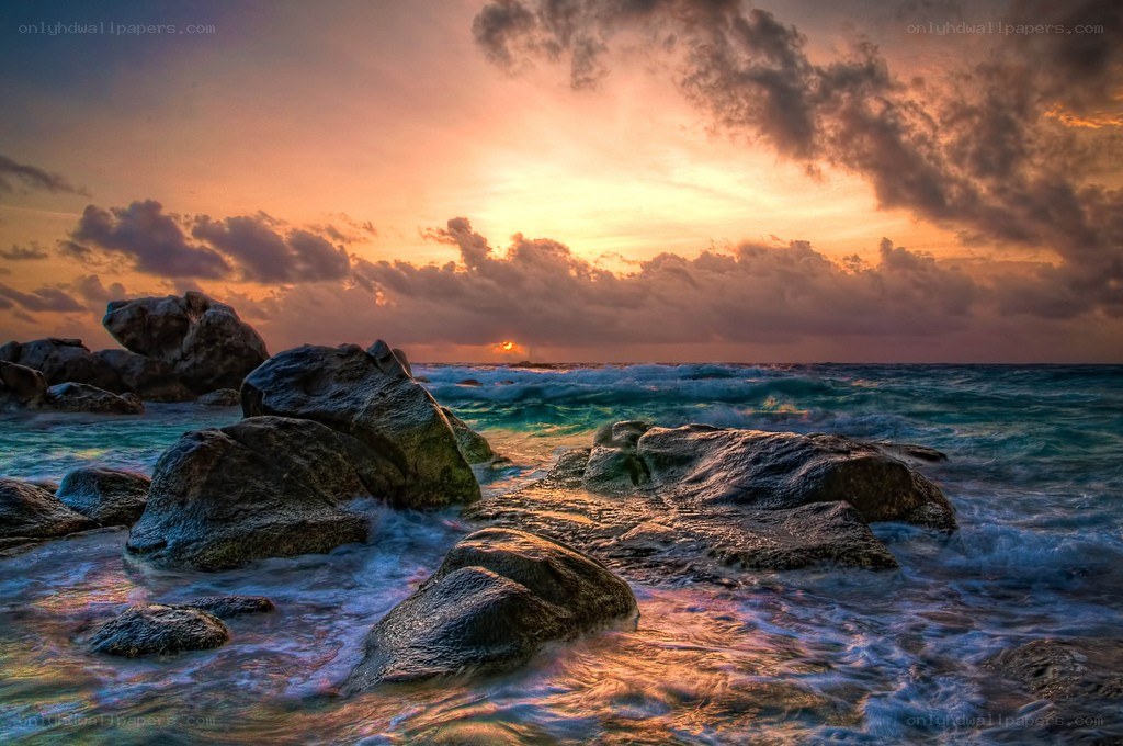 Sunset over rocky coastline