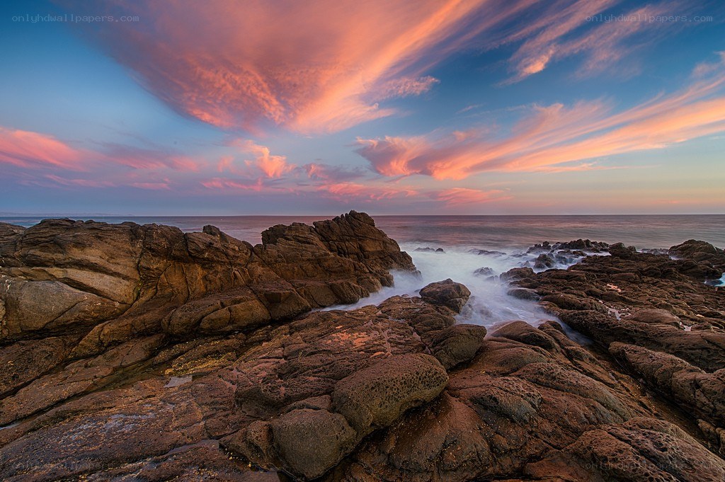 Sunset over rocky coastline