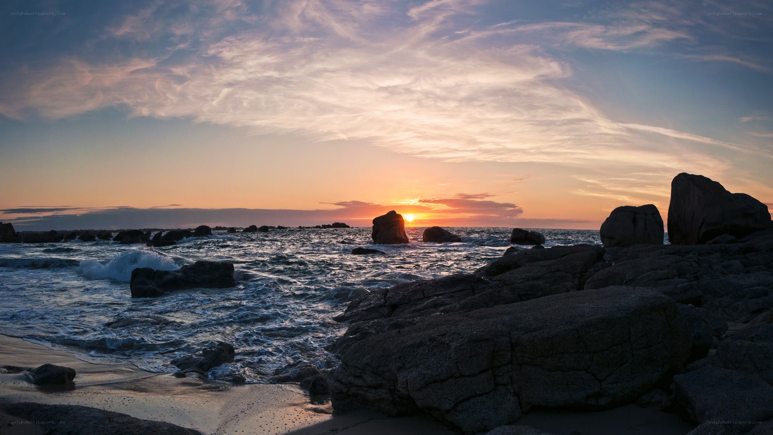 Sunset over rocky coastline
