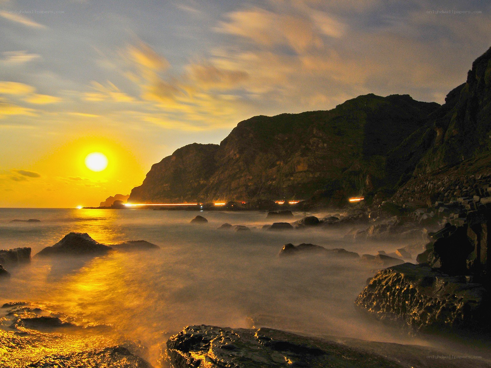 Sunset over rocky coastline
