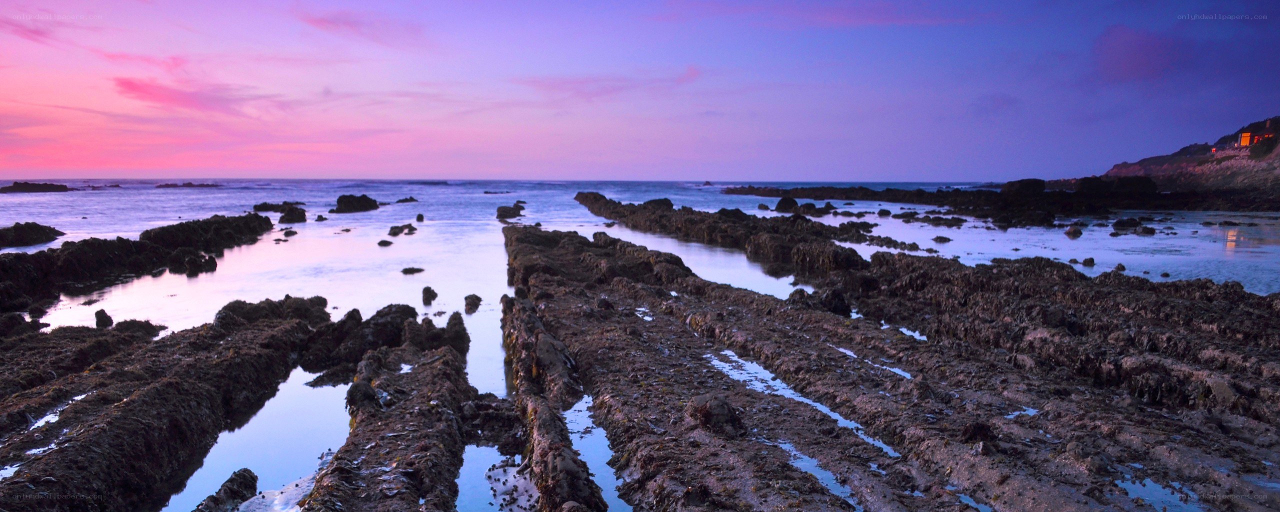 sunset over rocky coastline