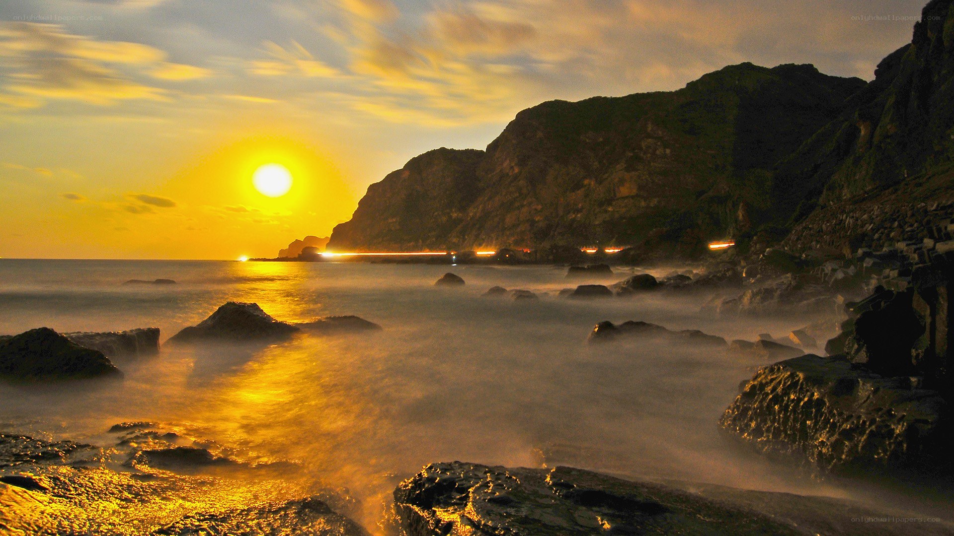 Sunset over rocky coastline