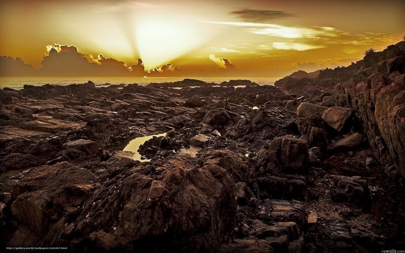 Sunset over rocky coastline