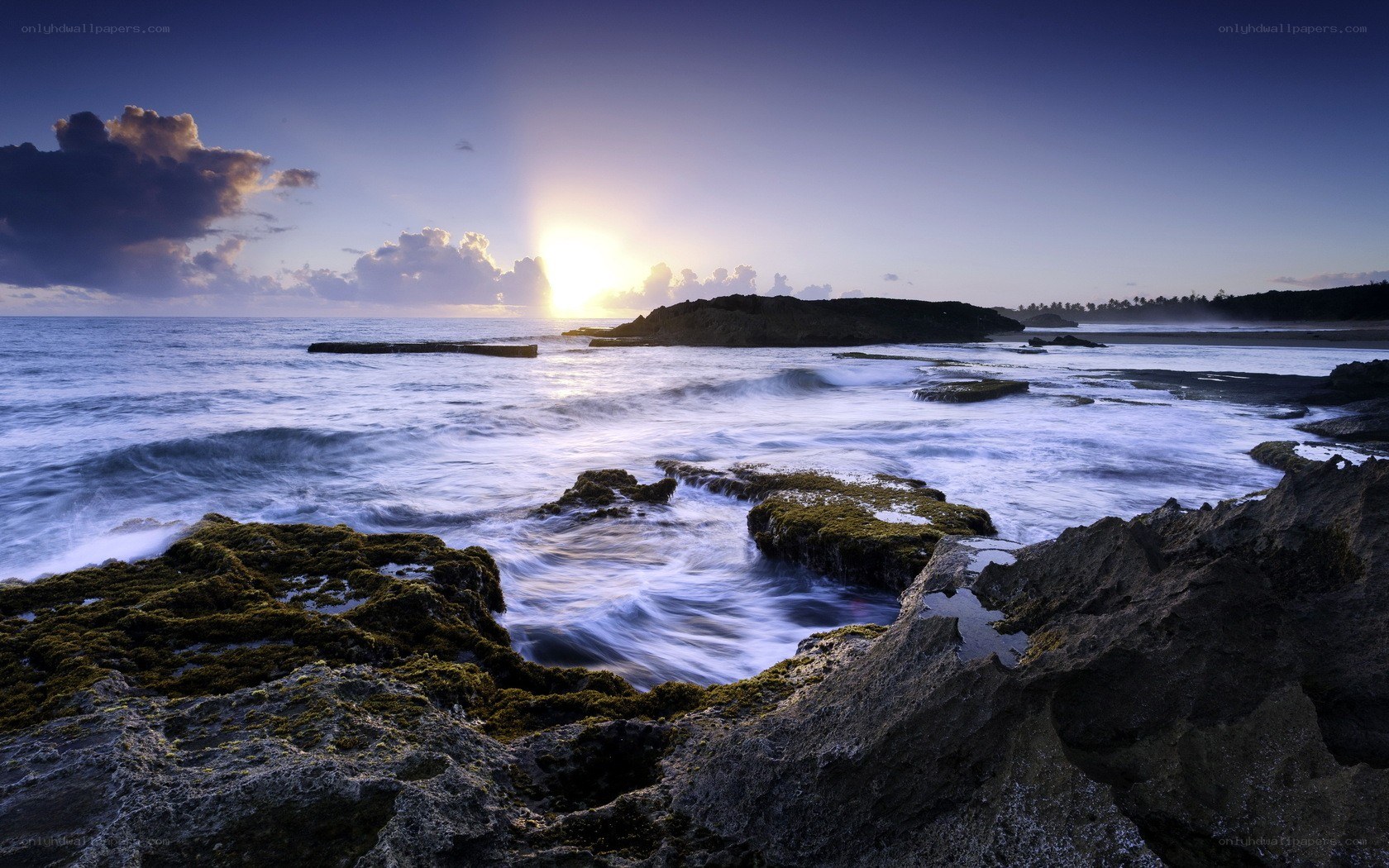 Sunset over rocky coastline
