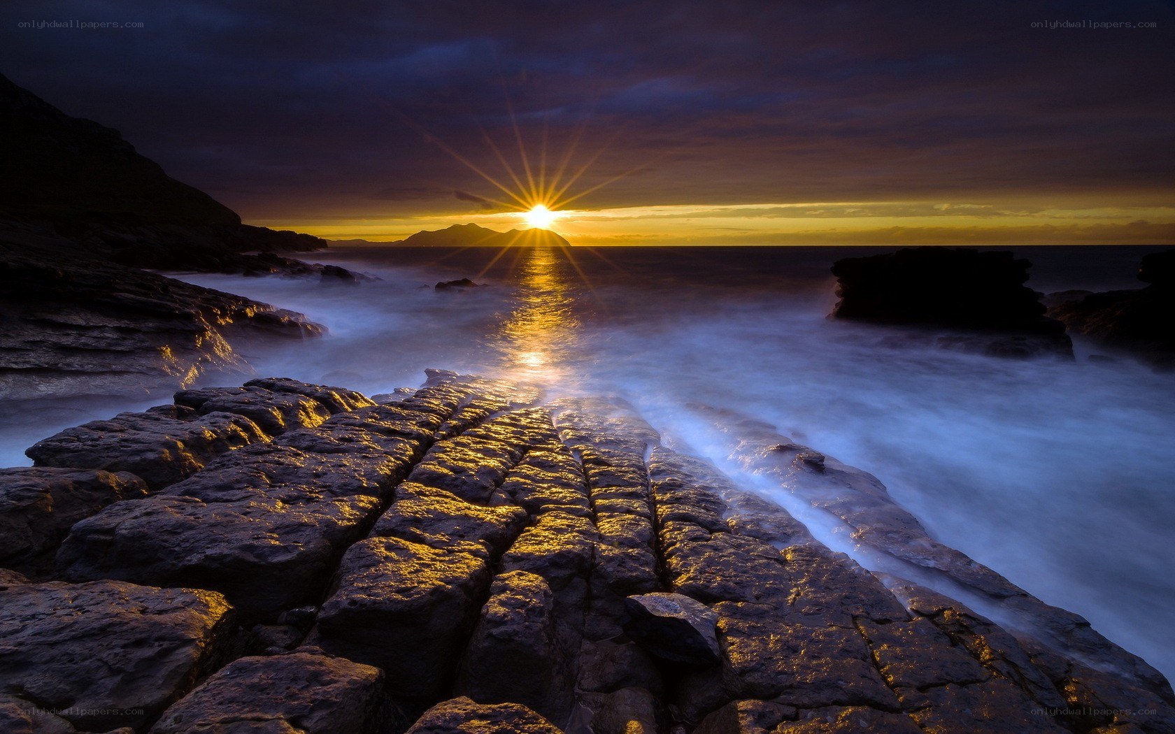Sunset over rocky coastline