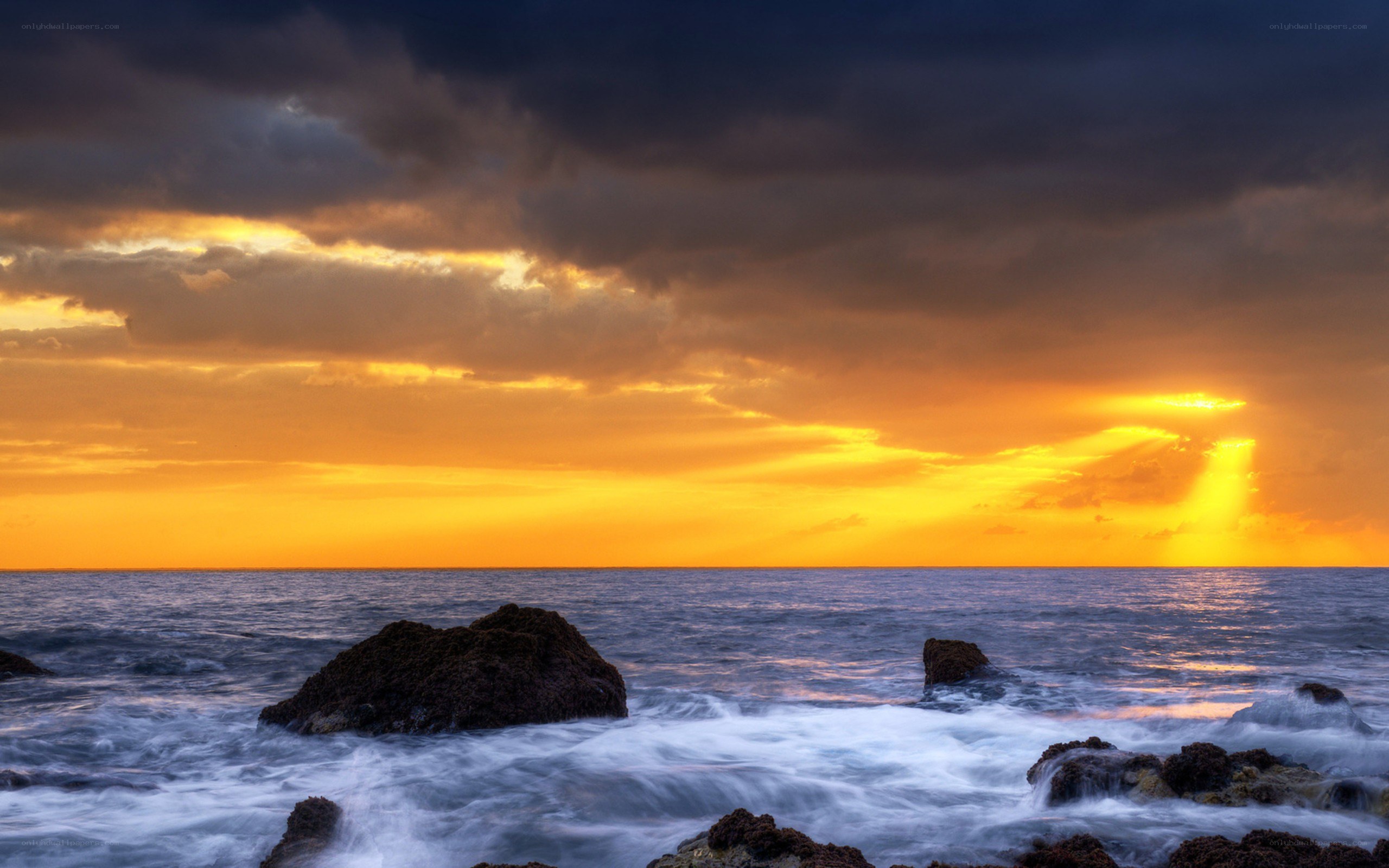 Sunset over rocky coastline