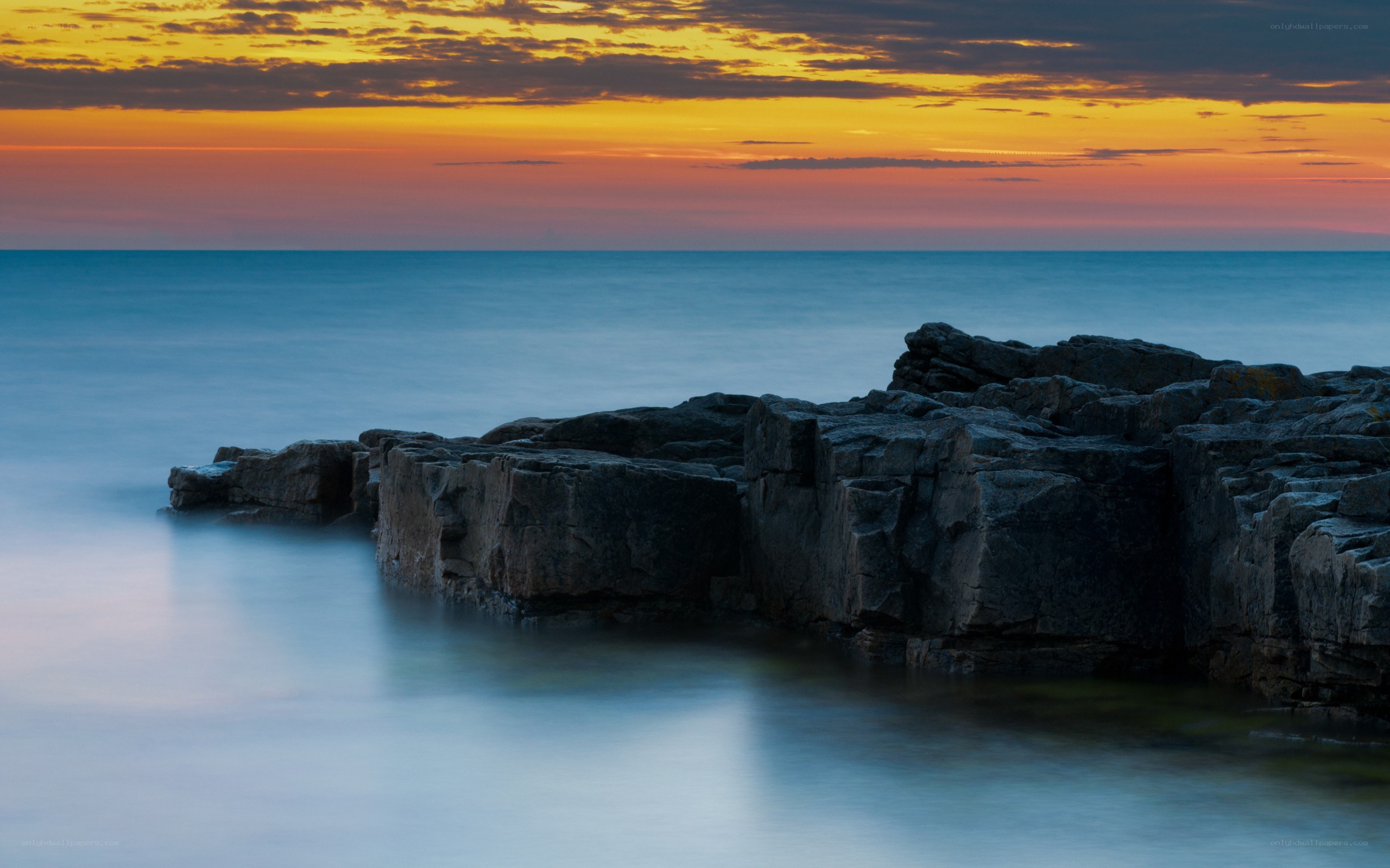 Sunset over rocky coastline