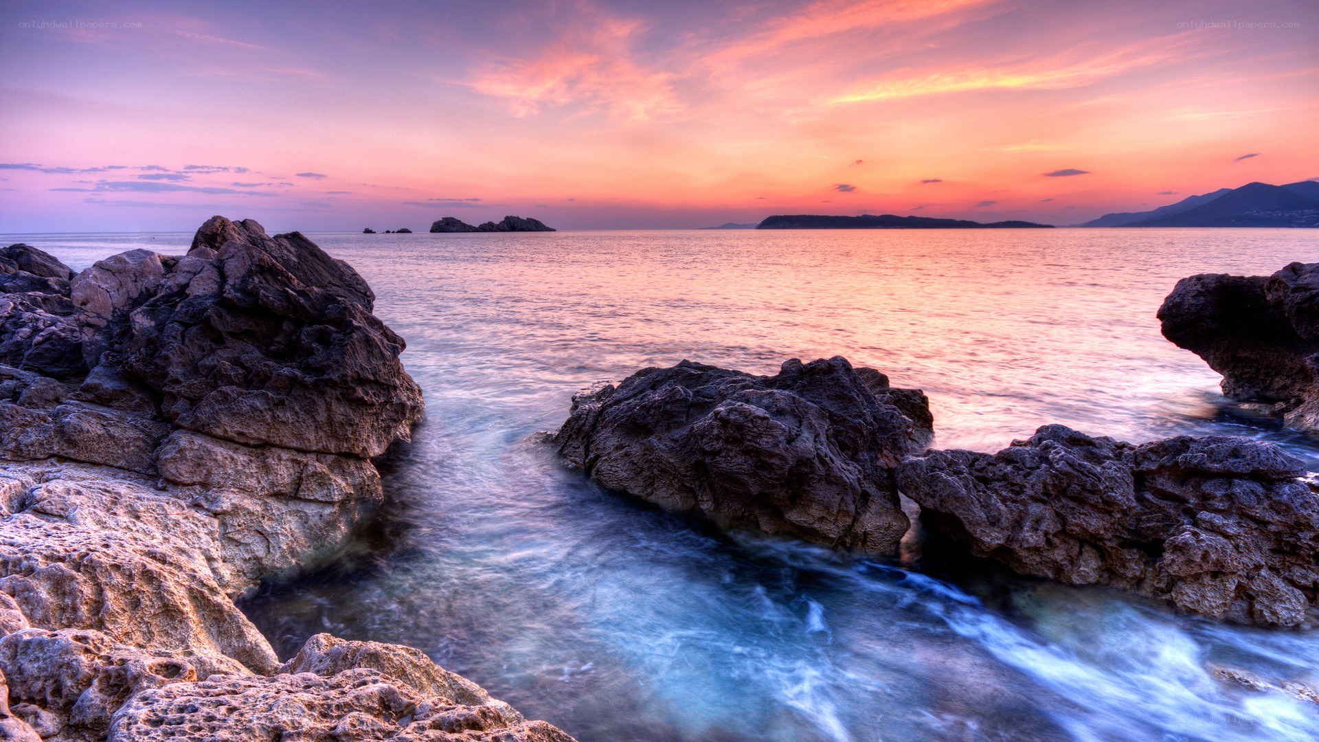 Sunset over rocky coastline