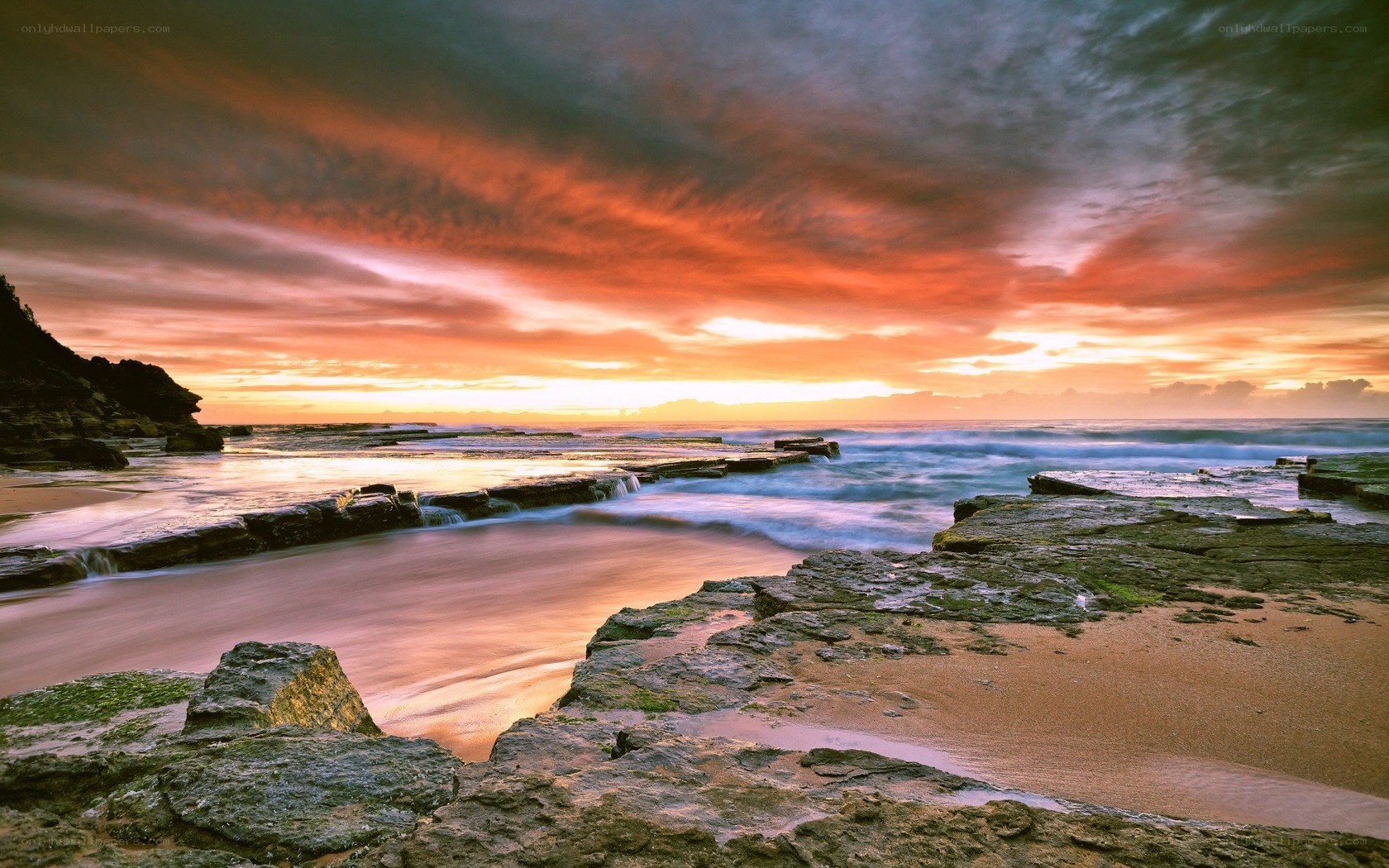 Sunset over rocky coastline