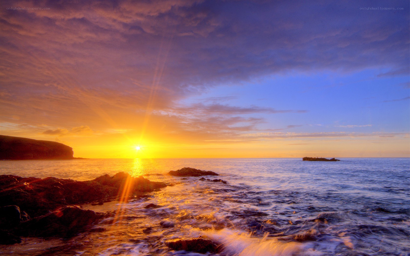 Sunset over rocky coastline