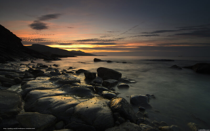 Sunset over rocky coastline