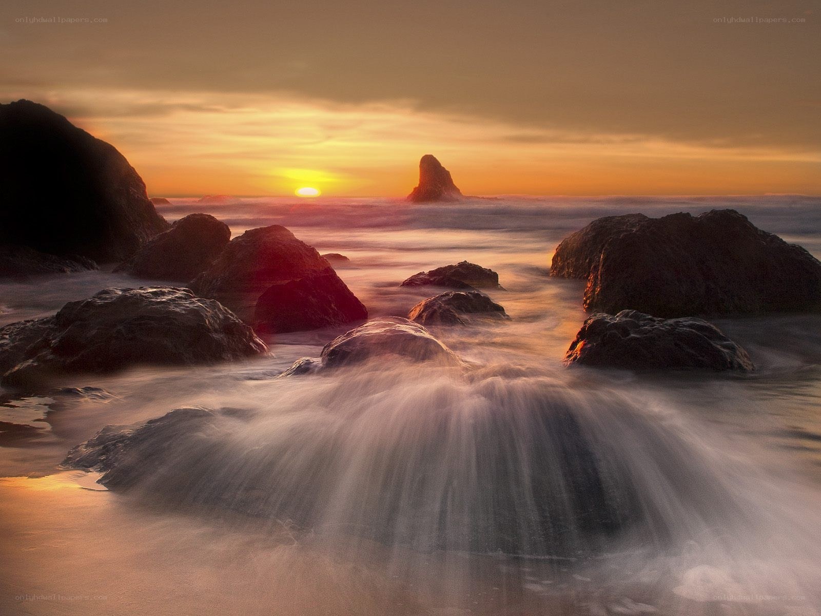 Sunset over rocky coastline