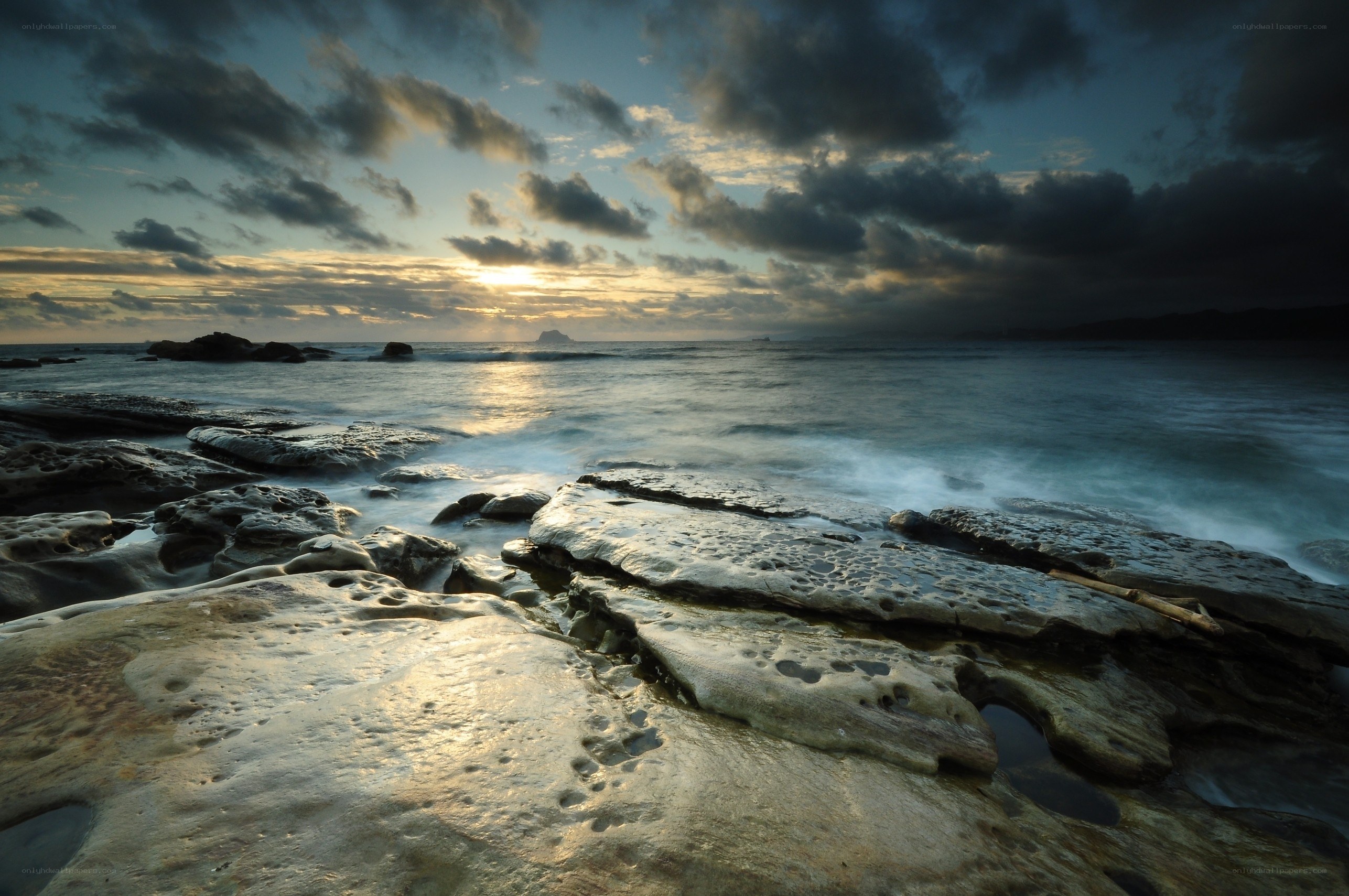Sunset over rocky coastline
