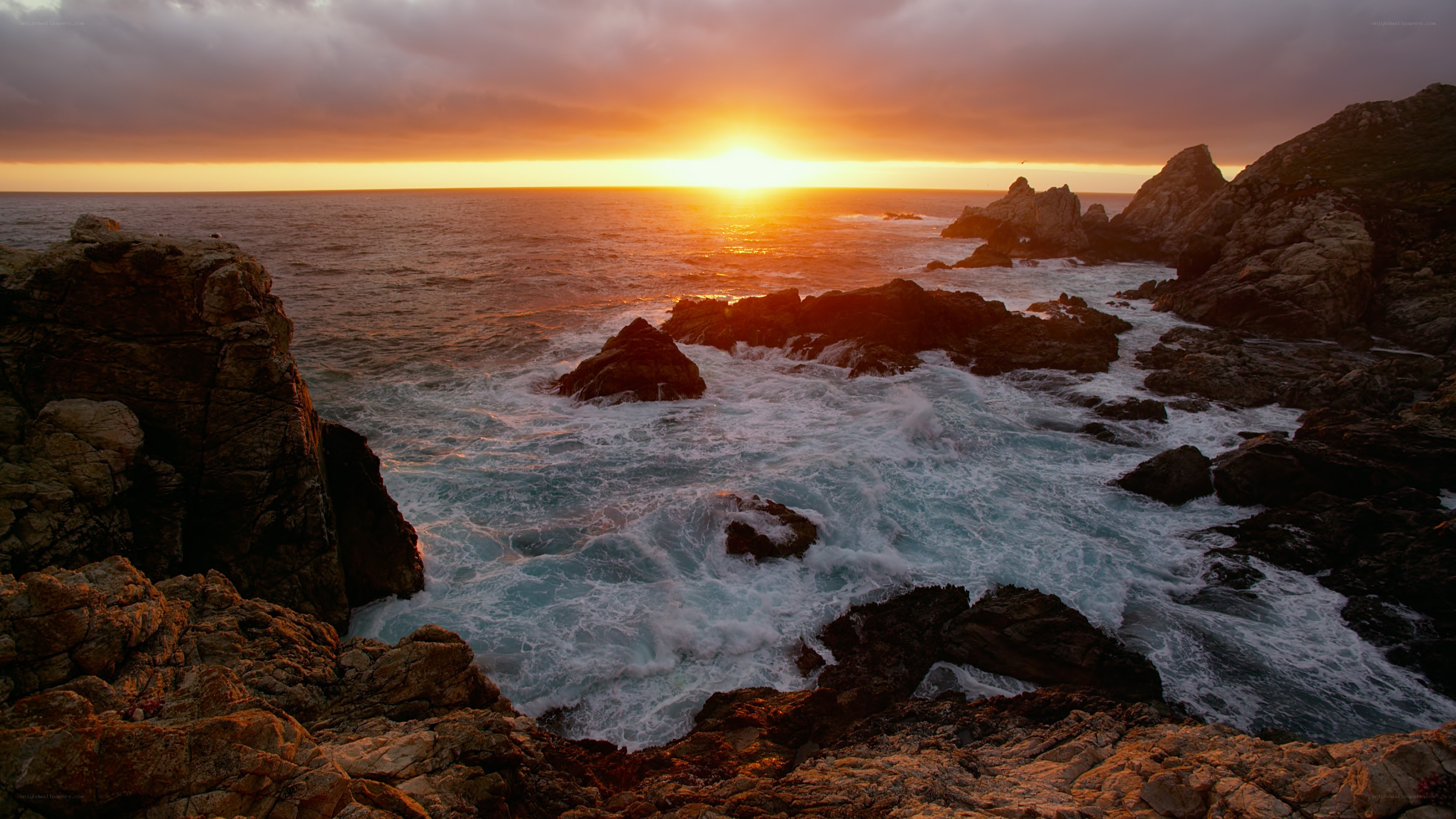 Sunset over rocky coastline