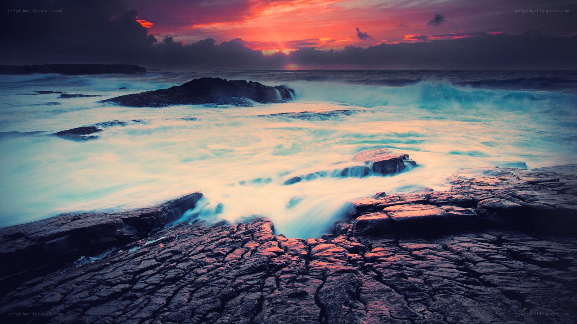 Sunset over rocky coastline