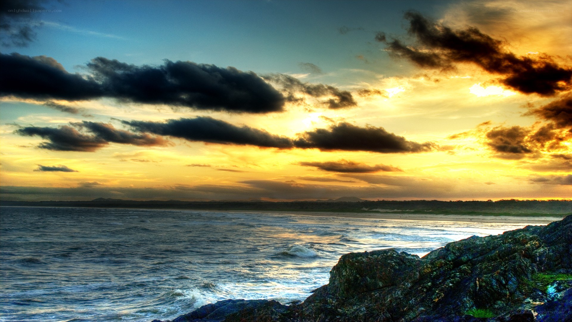 Sunset over rocky coastline