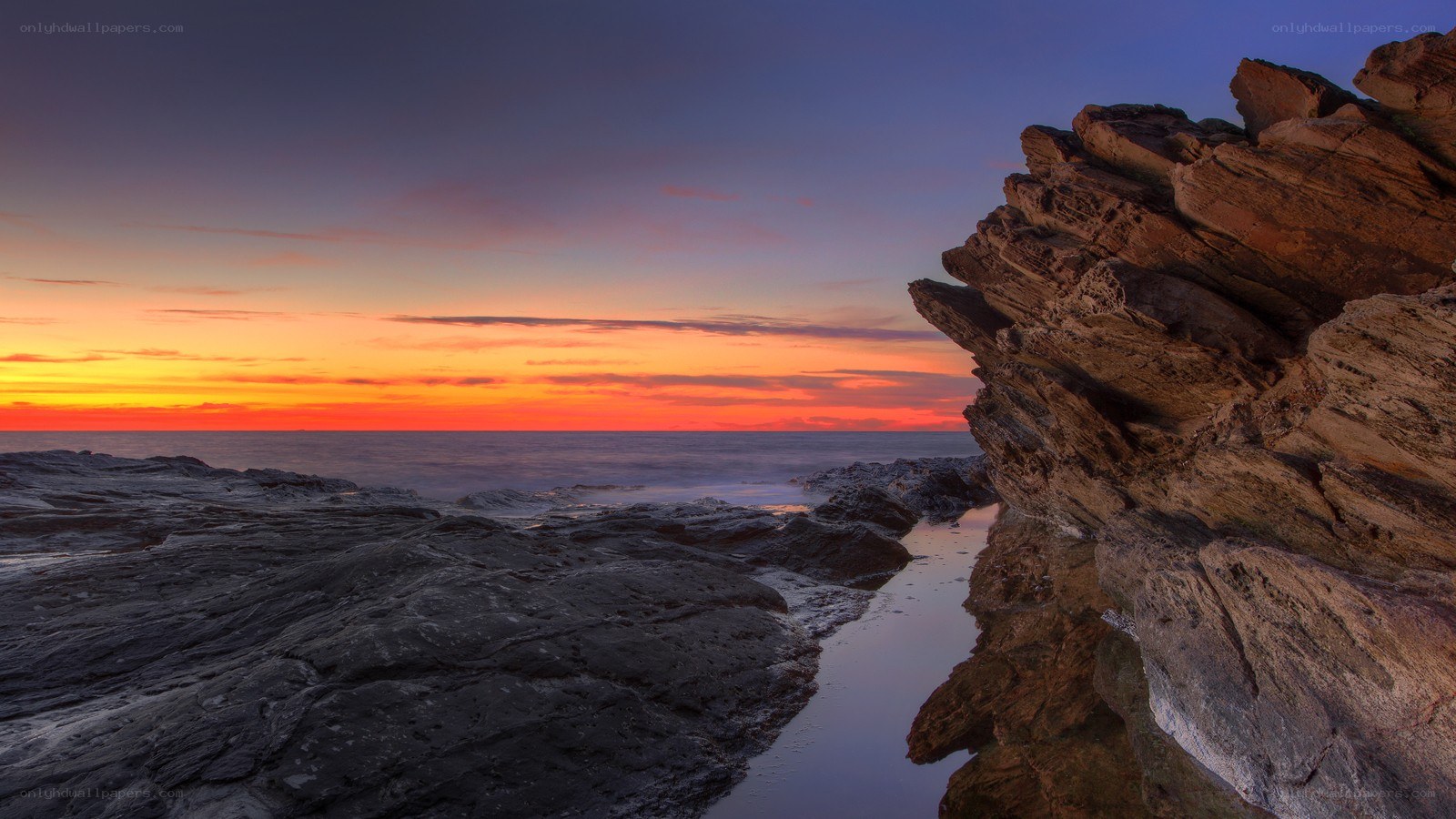 Sunset over rocky coastline