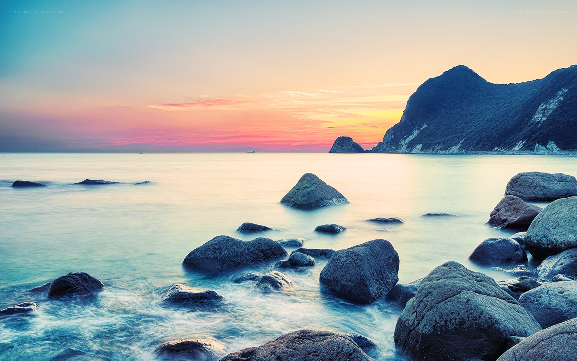 Sunset over rocky coastline