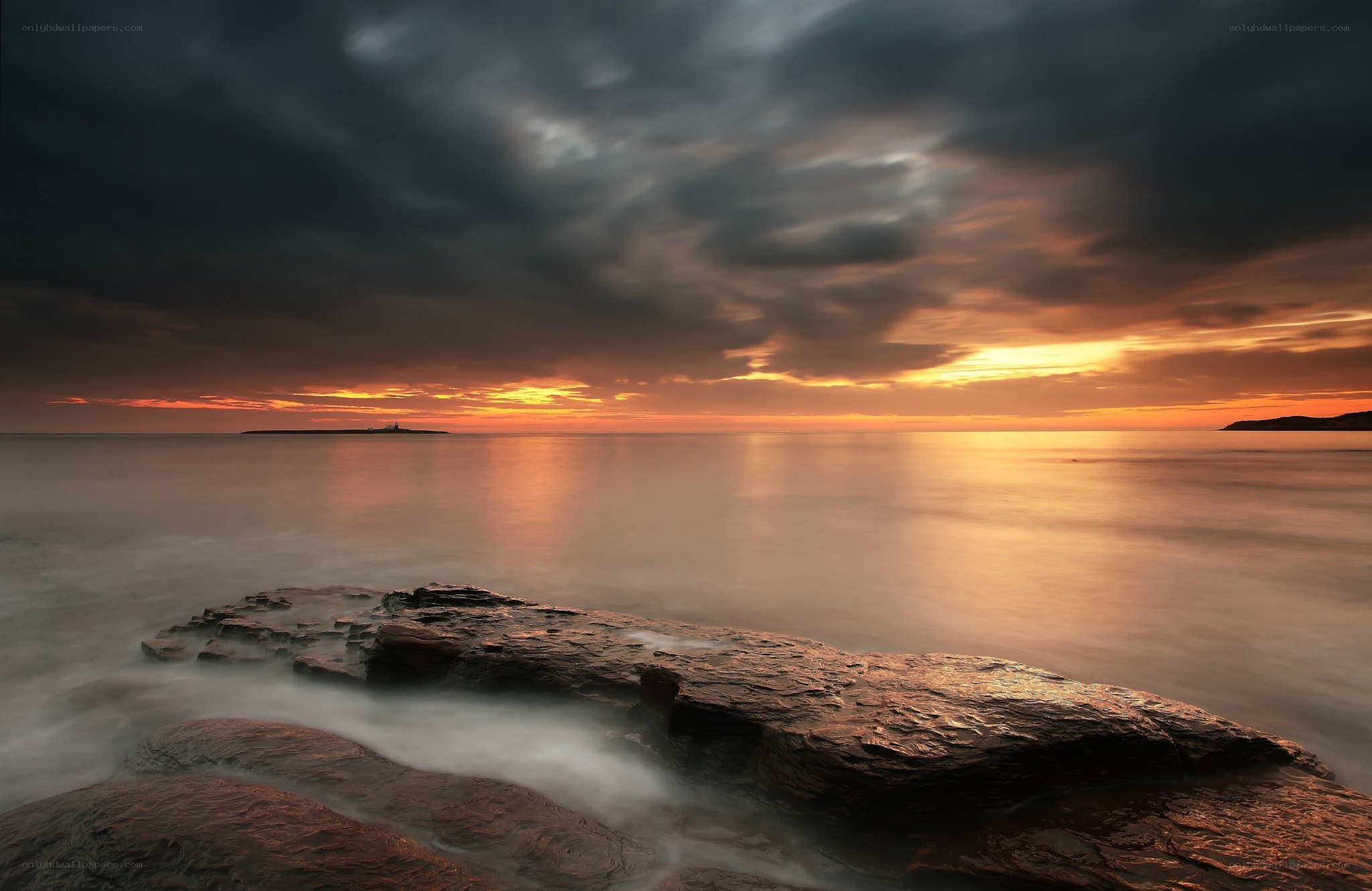 Sunset over rocky coastline