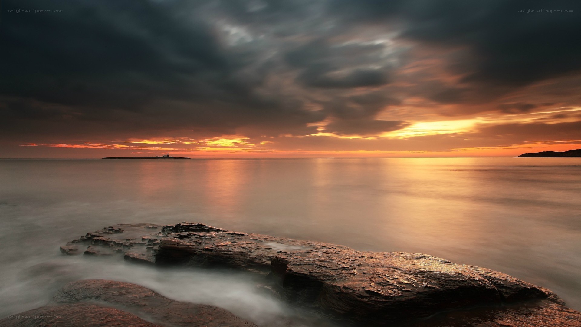 Sunset over rocky coastline