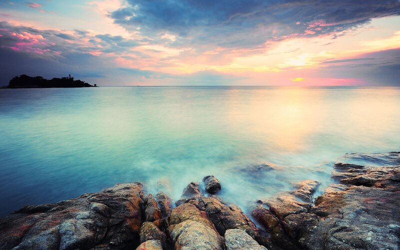 Sunset over rocky coastline