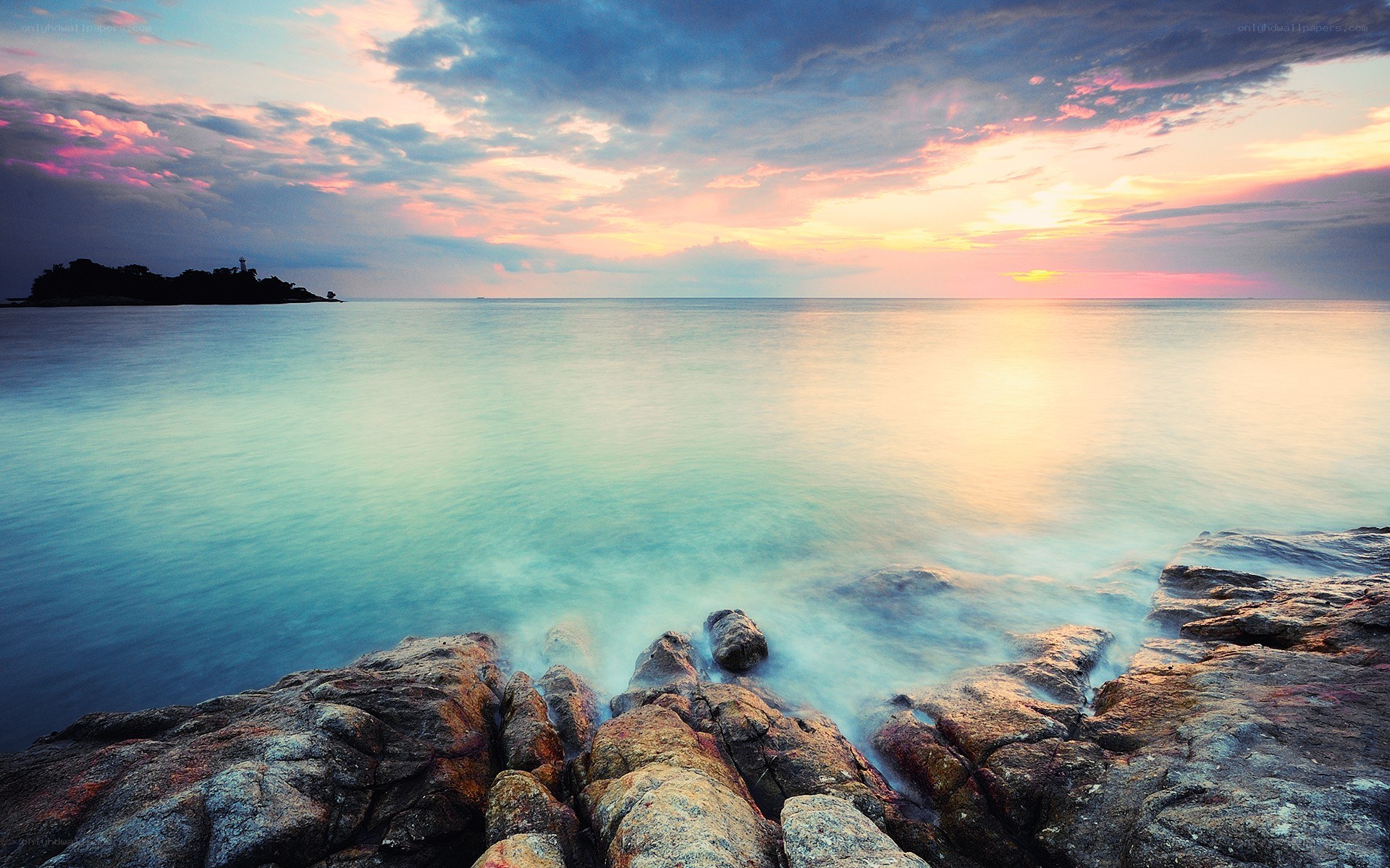 Sunset over rocky coastline