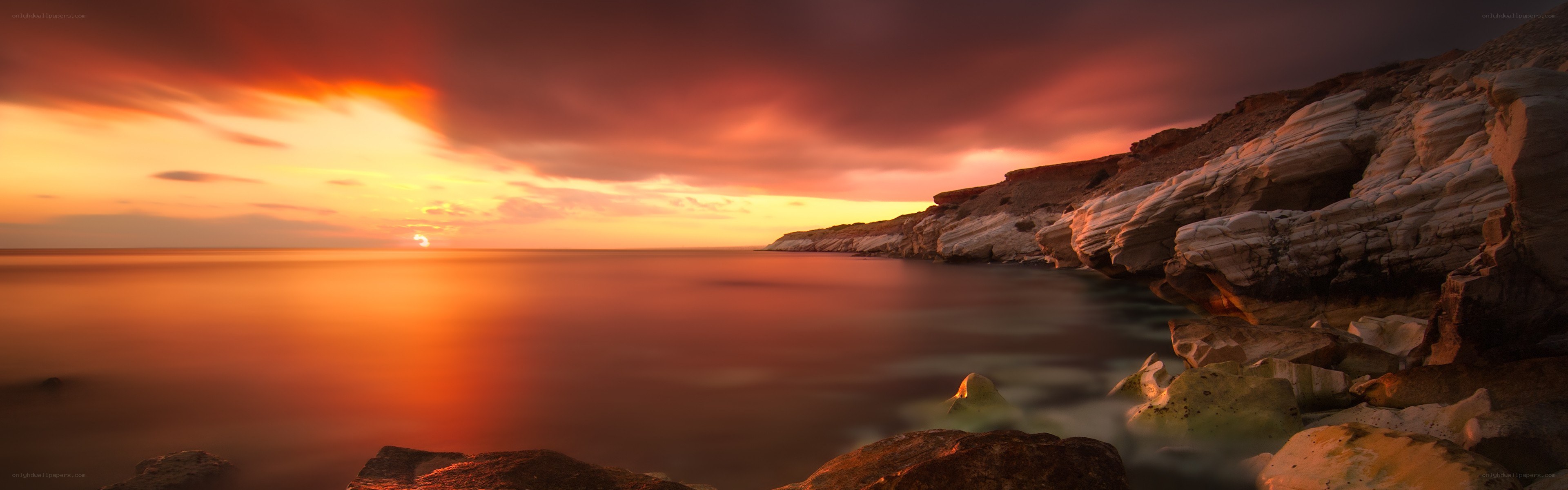 Sunset over rocky coastline