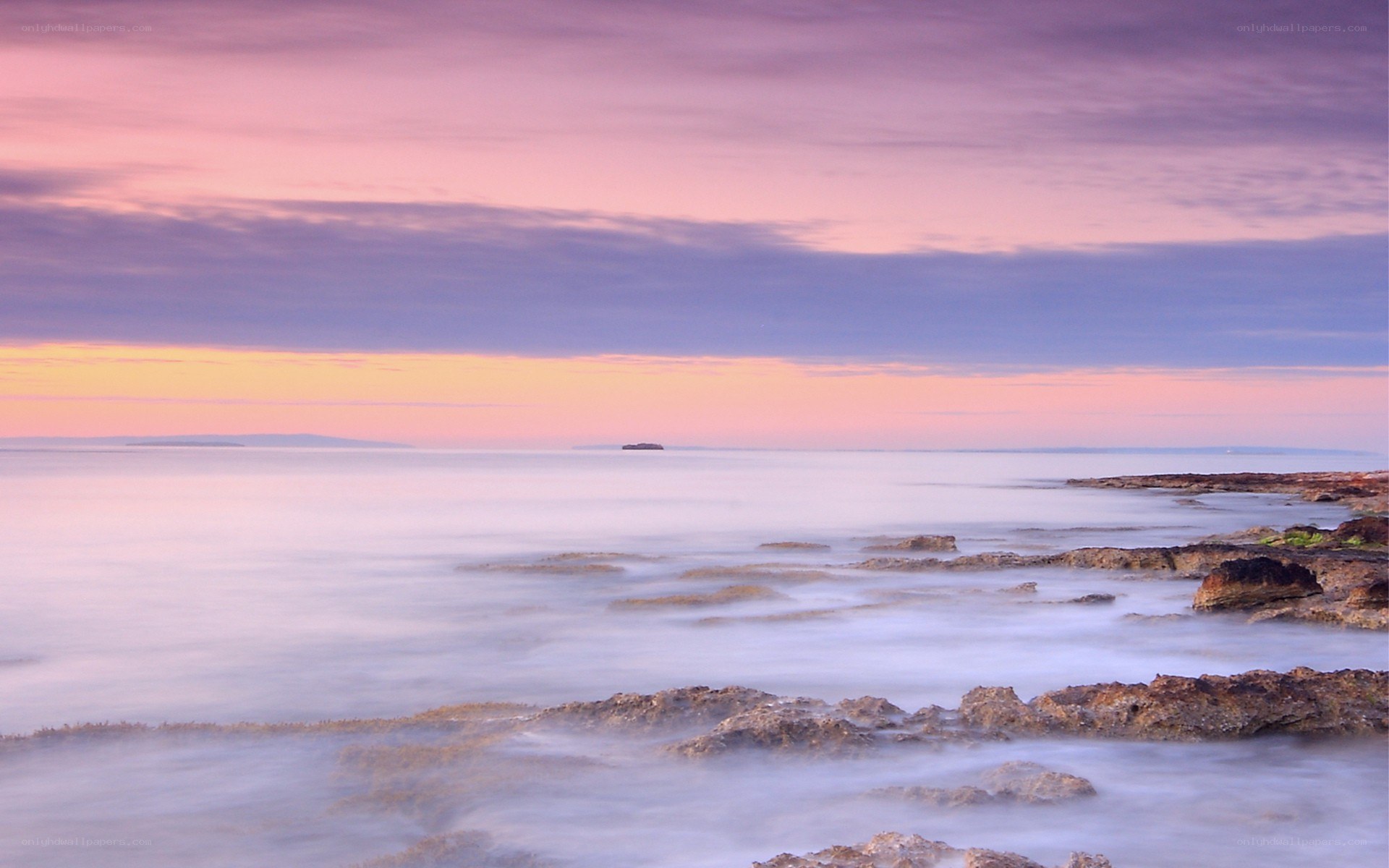 Sunset over rocky coastline