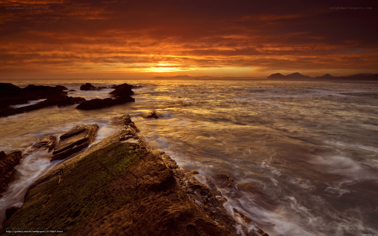Sunset over rocky coastline