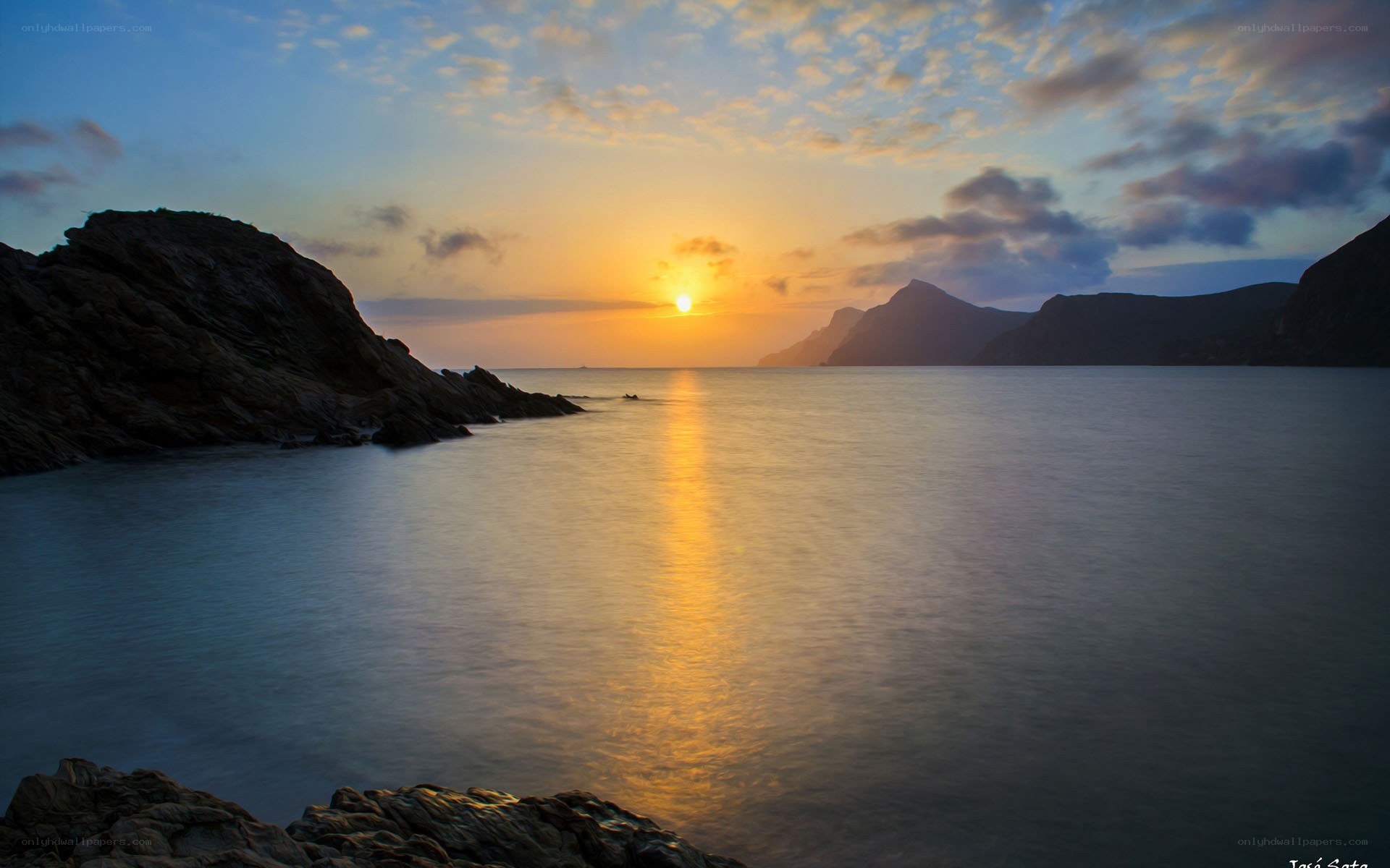 Sunset over rocky coastline