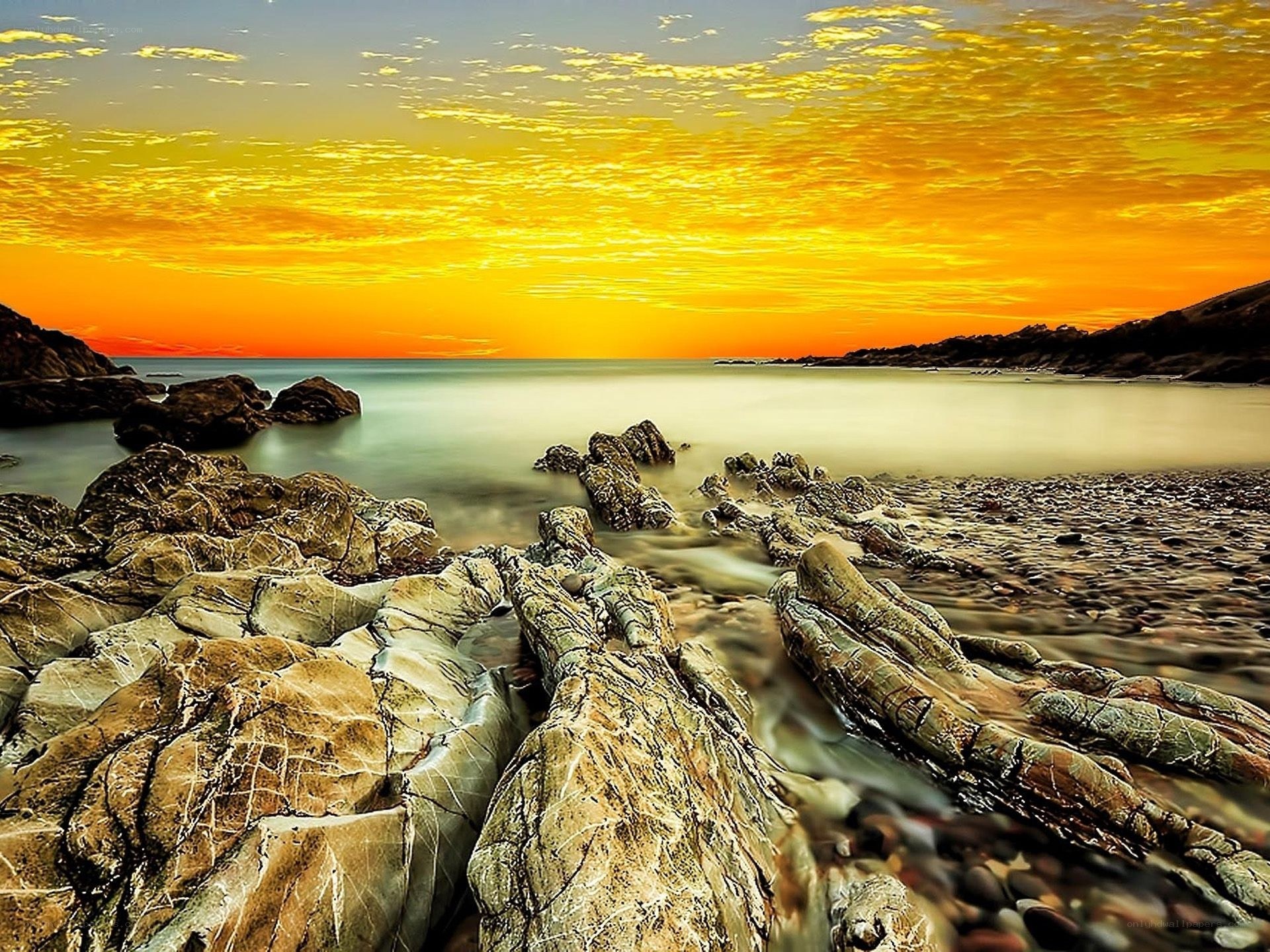 Sunset over rocky coastline