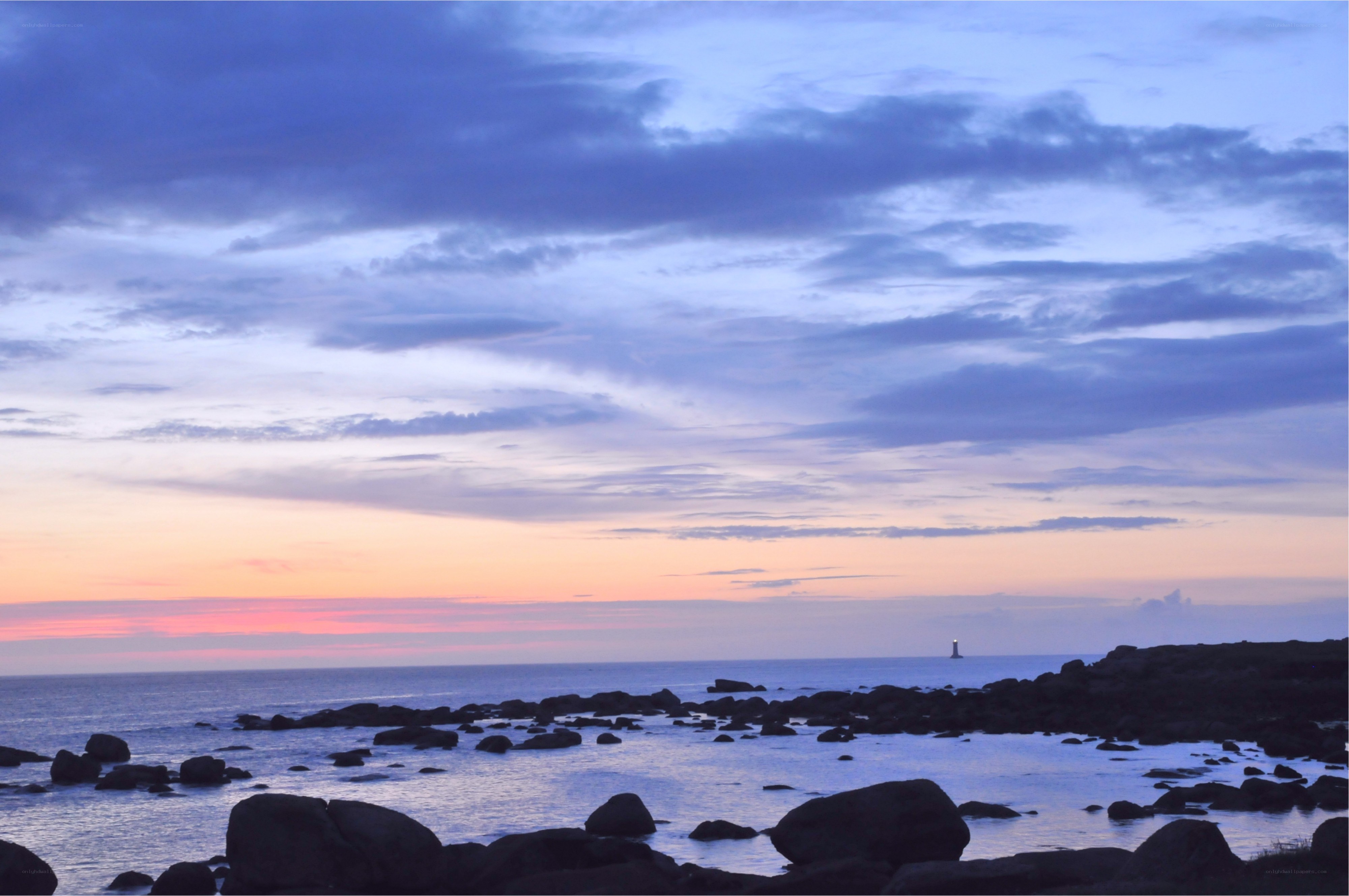 Sunset over rocky coastline