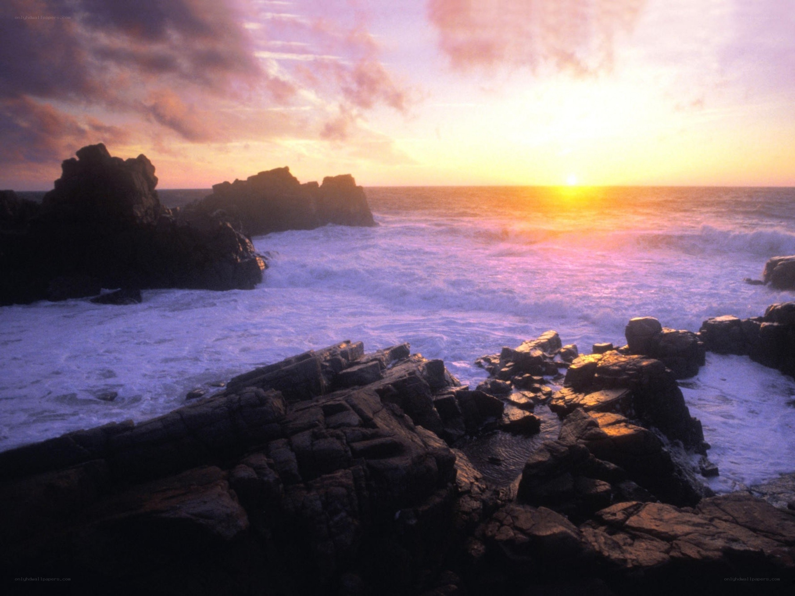 Sunset over rocky coastline