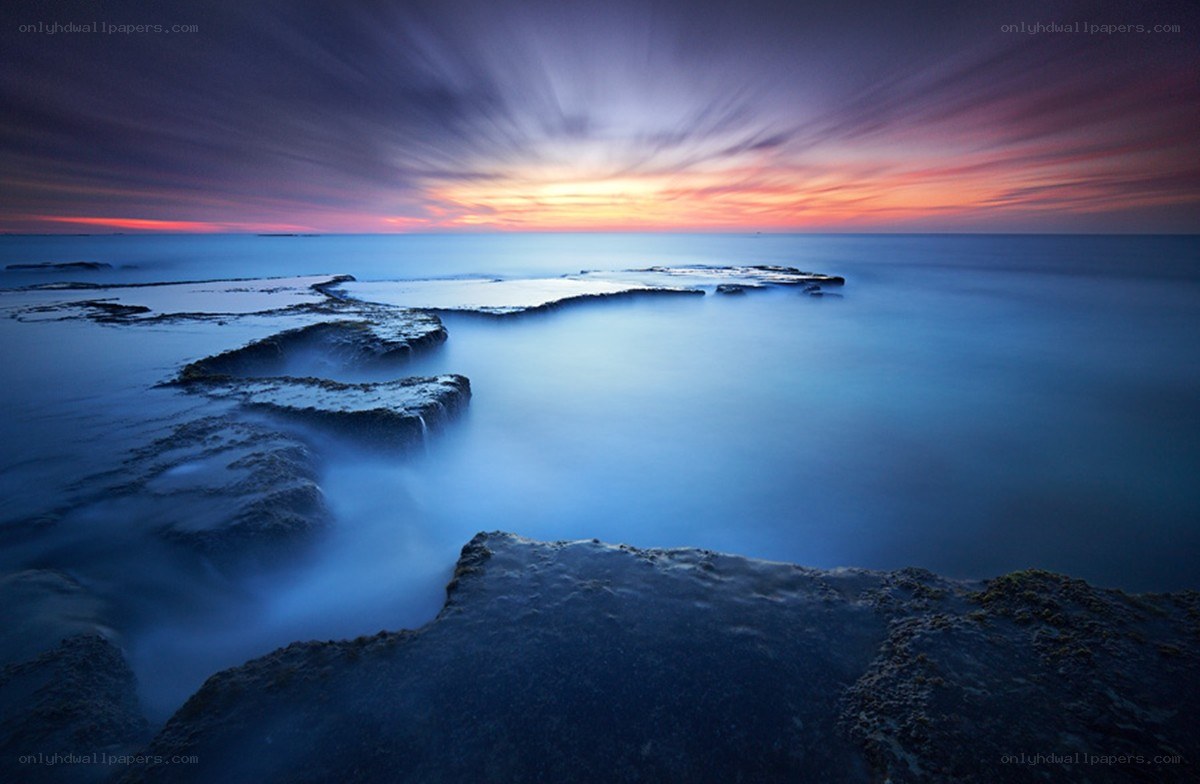 Sunset over rocky coastline