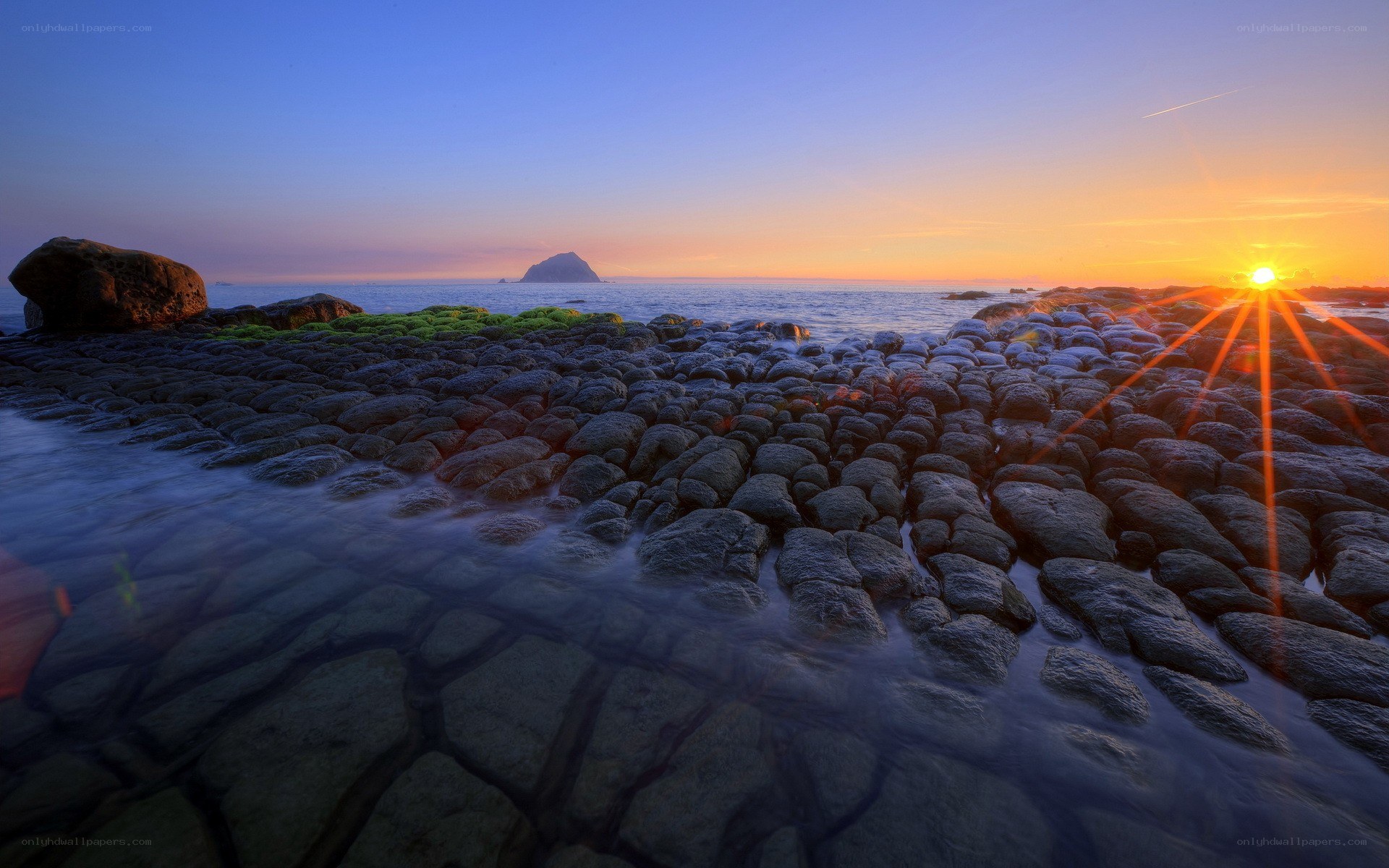 Sunset over rocky coastline
