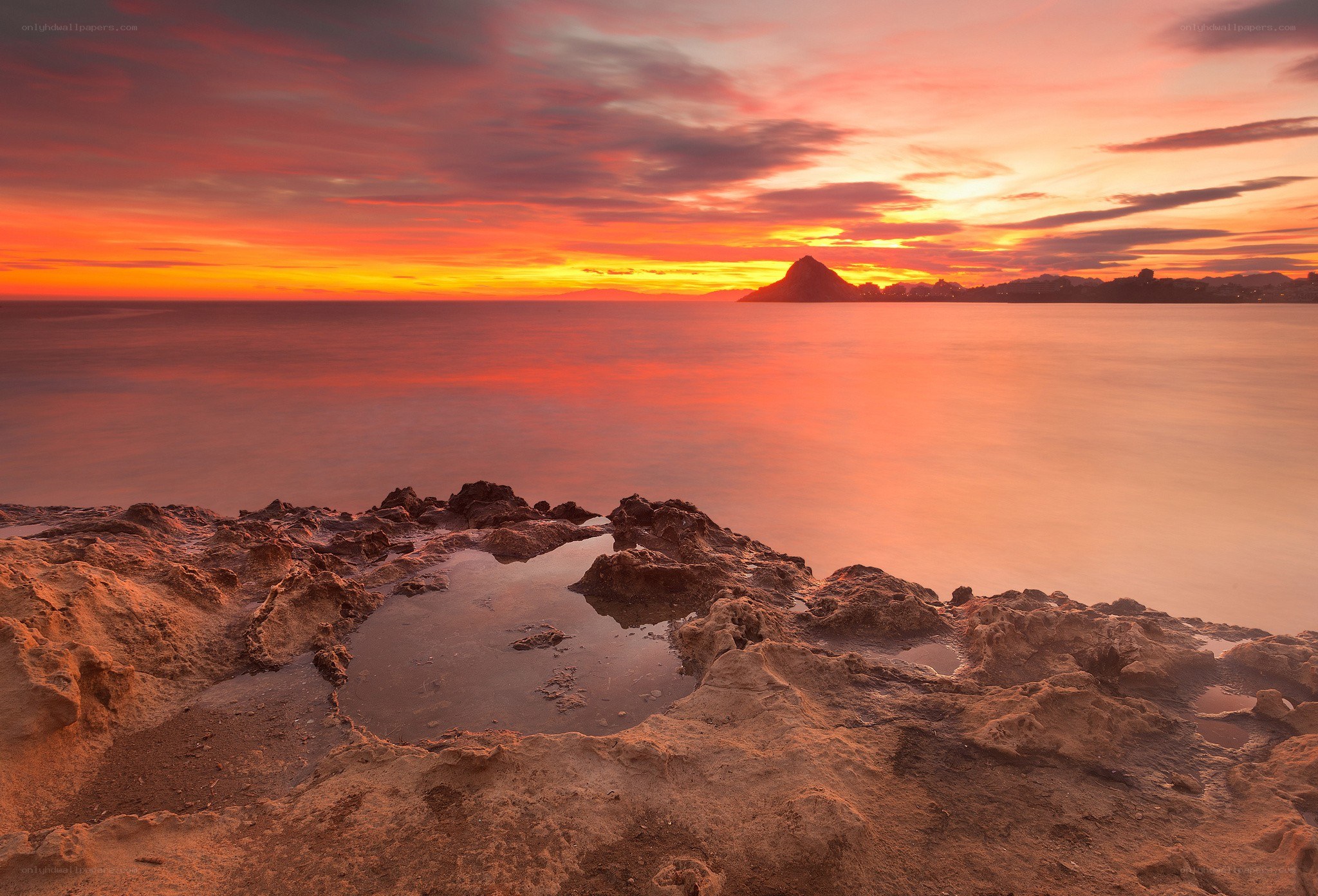 Sunset over rocky coastline