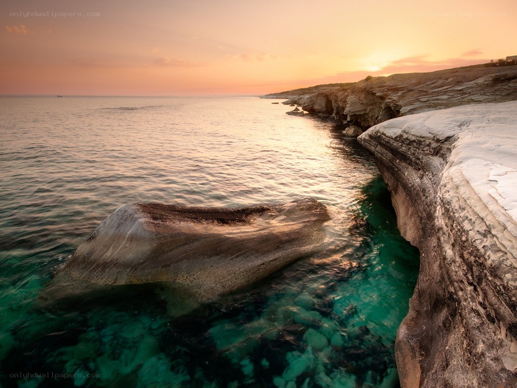 Sunset over rocky coastline