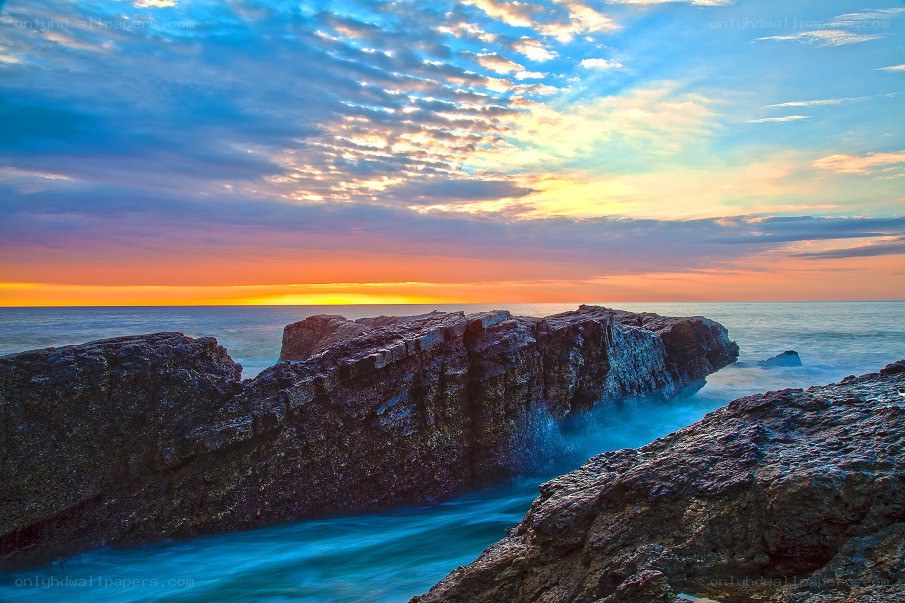 Sunset over rocky coastline