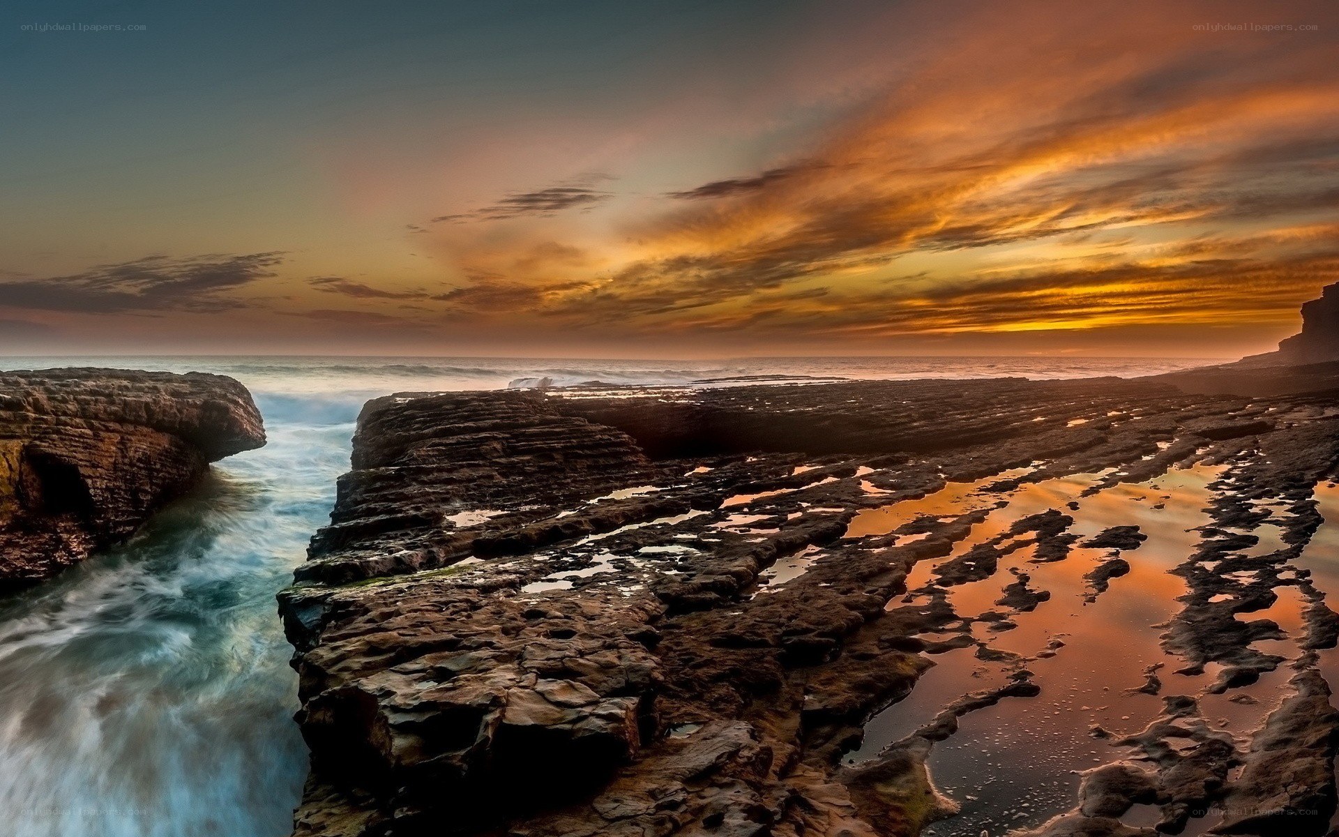 Sunset over rocky coastline