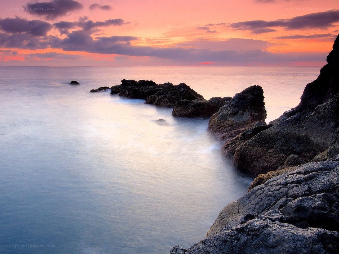 Sunset over rocky coastline