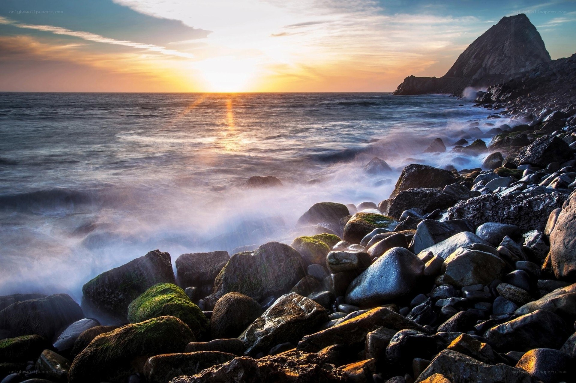 Sunset over rocky coastline