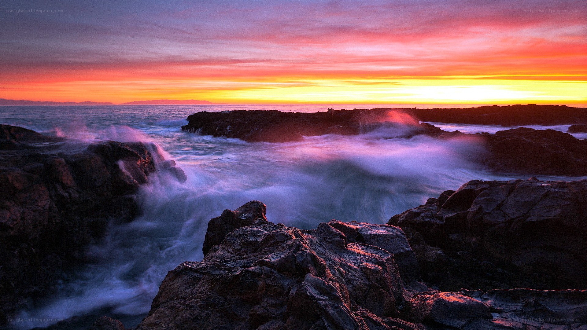 Sunset over rocky coastline
