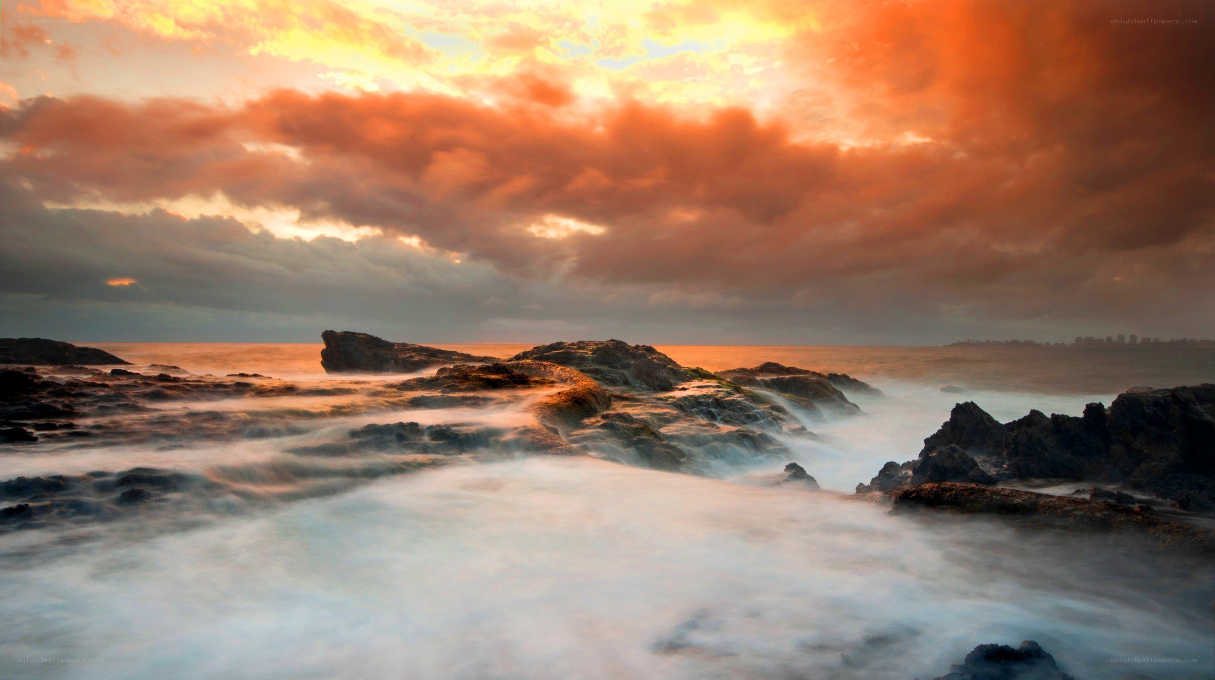 Sunset over rocky coastline