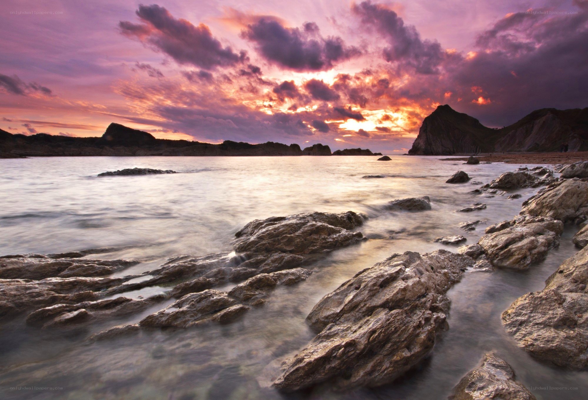 Sunset over rocky coastline