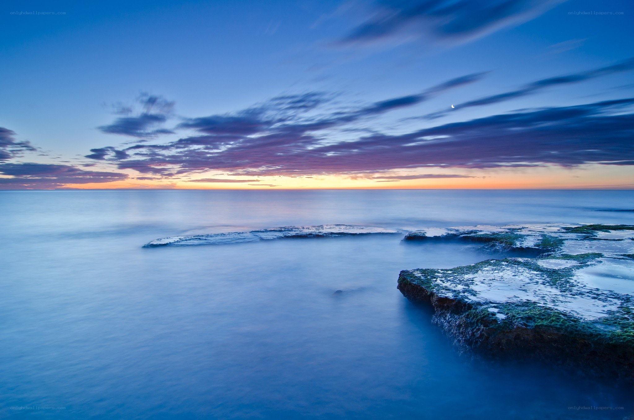 Sunset over rocky coastline