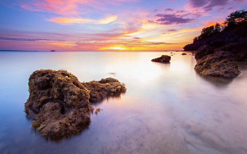 Sunset over rocky coastline
