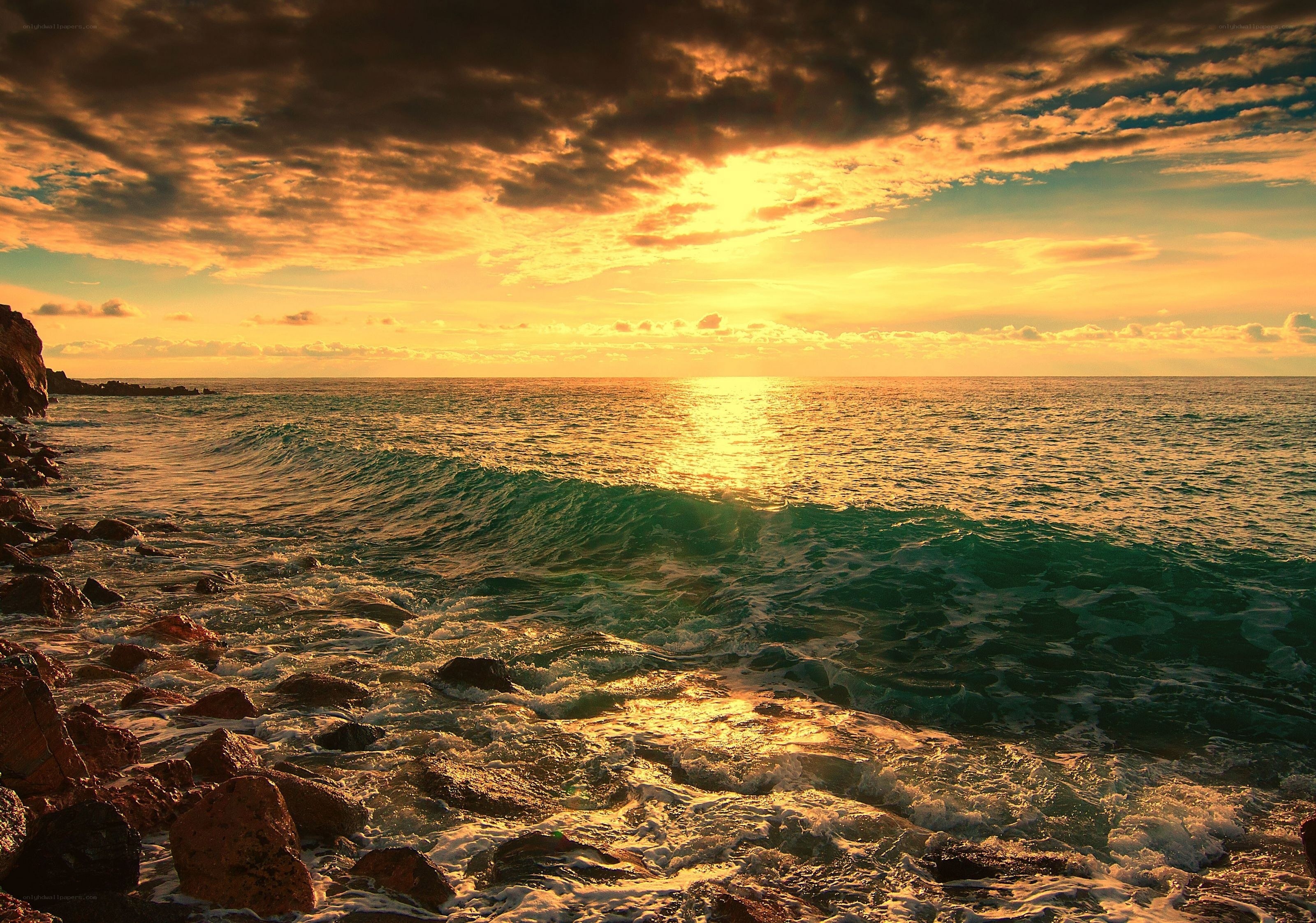 Sunset over rocky coastline