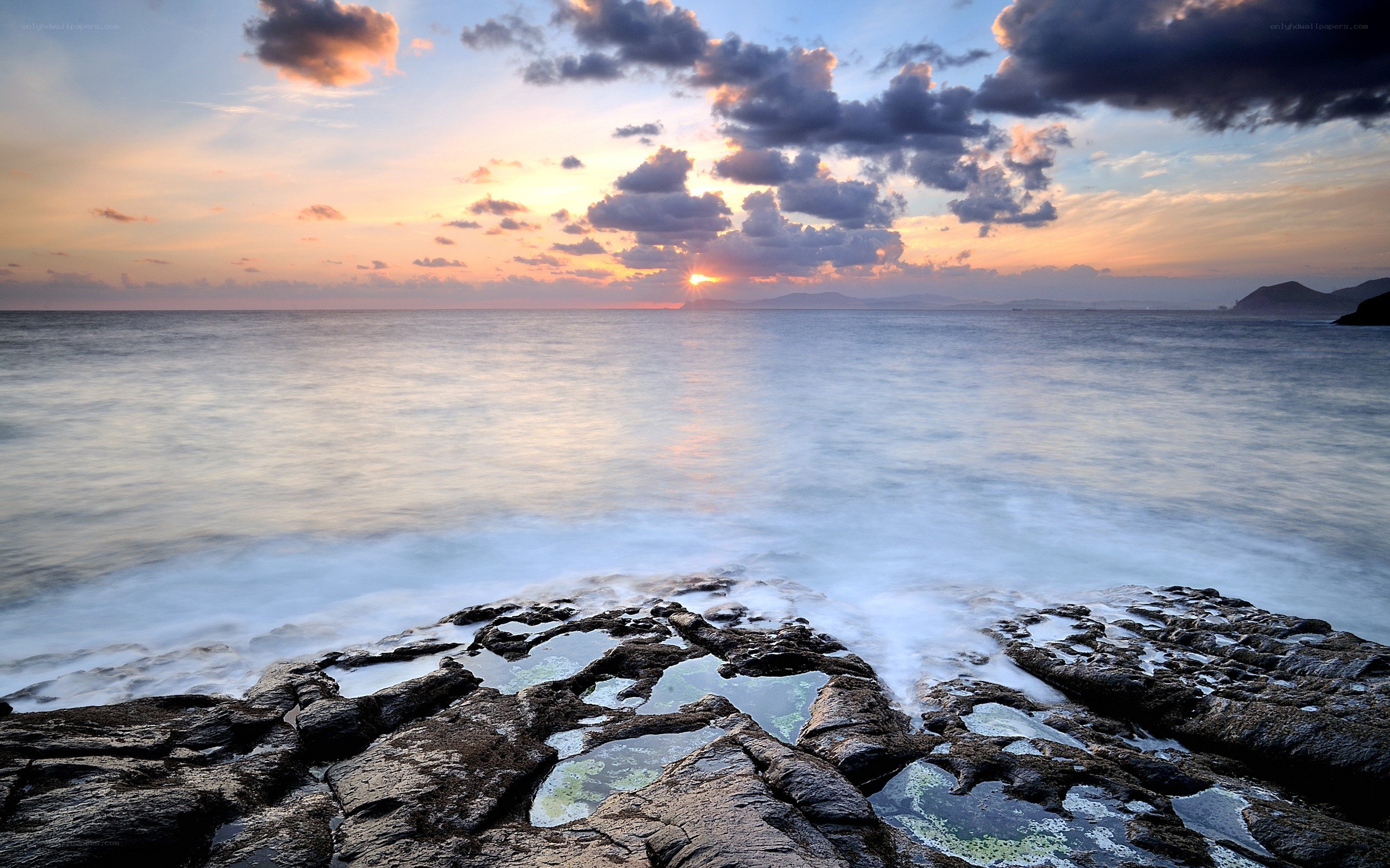 Sunset over rocky coastline