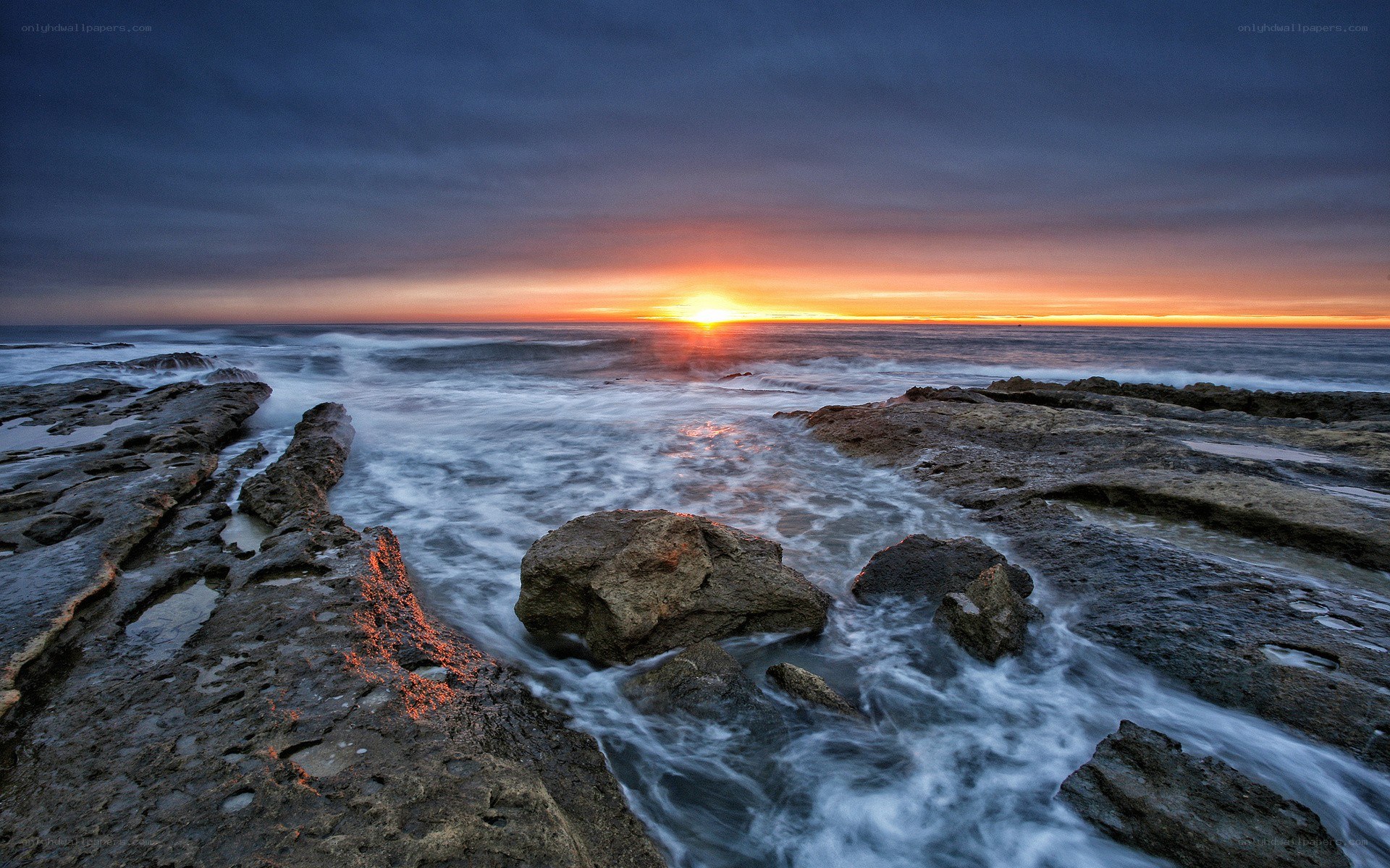 Sunset over rocky coastline