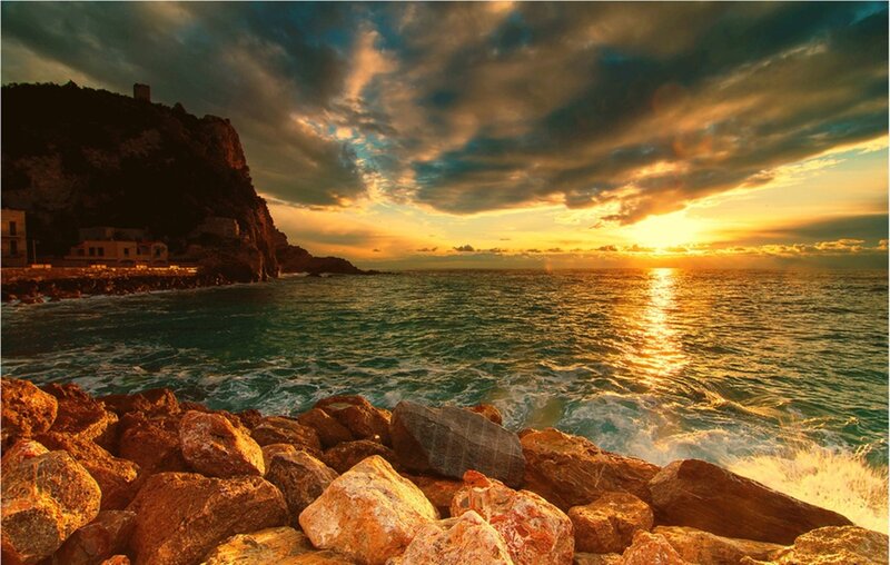 Sunset over rocky coastline